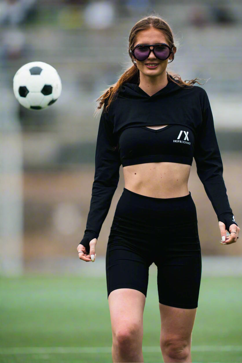tall white female model getting active on the soccer field while wearing black beunique 3 piece set black for the relentless