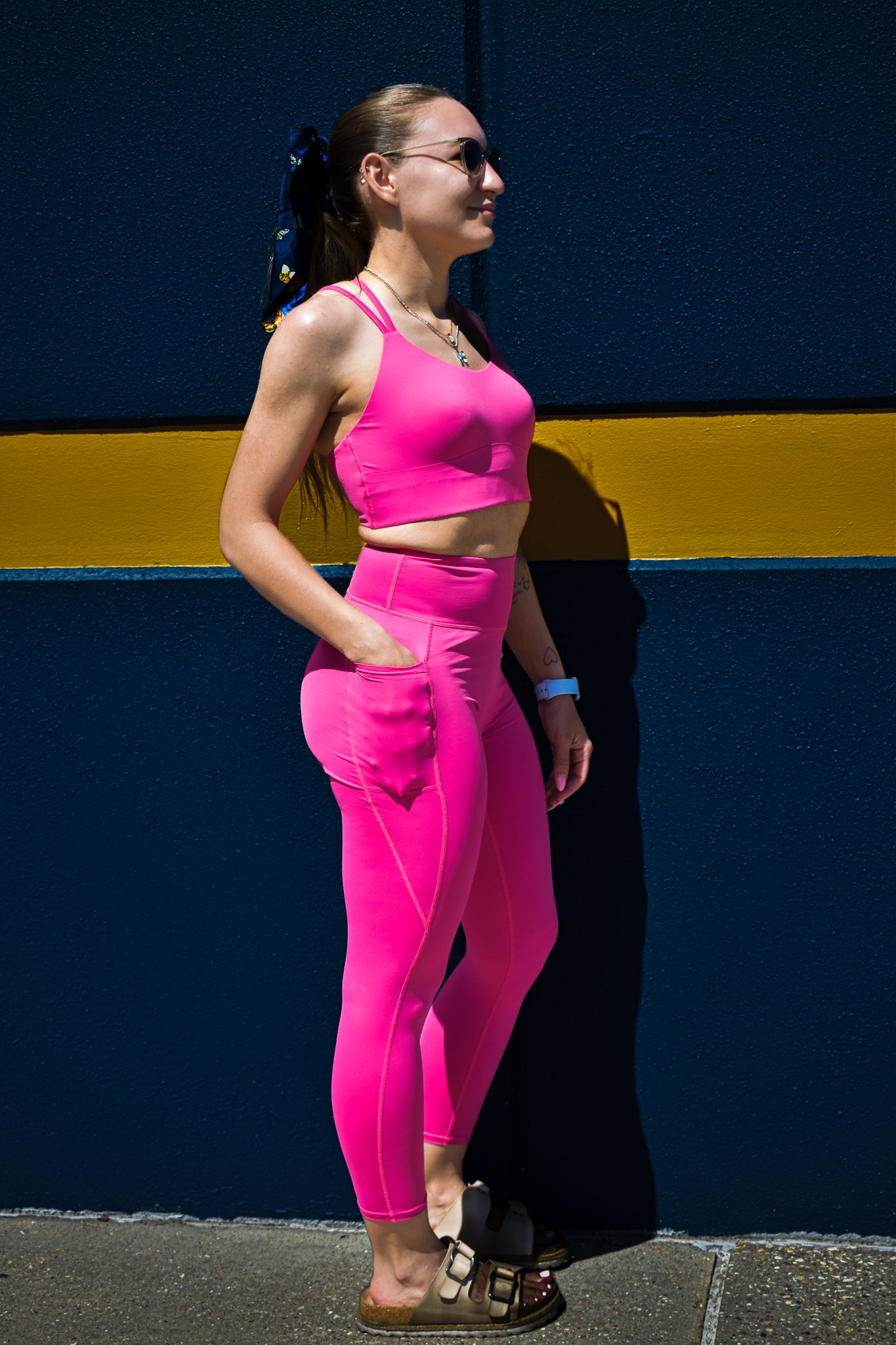 white model wearing inspr exchange athletica pink navigator sports bra and leggings set with pockets
