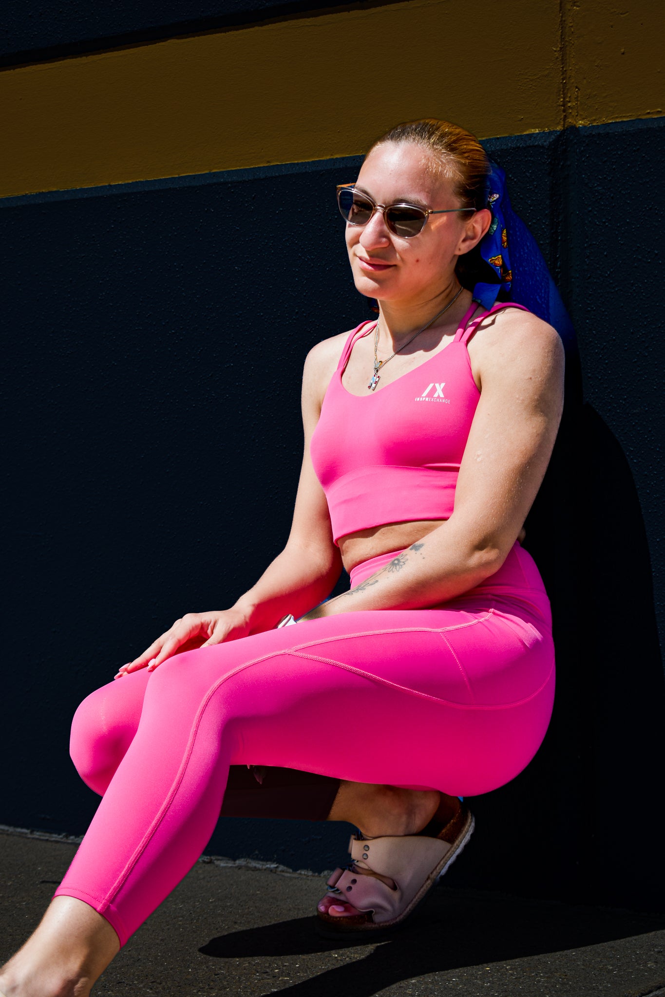 white model wearing inspr exchange athletica pink navigator sports bra and leggings set with pockets