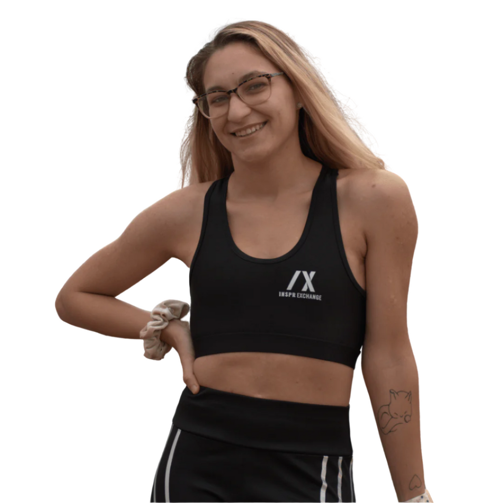 female athletic model posing for inspr exchange athletica while wearing black virago sport bra
