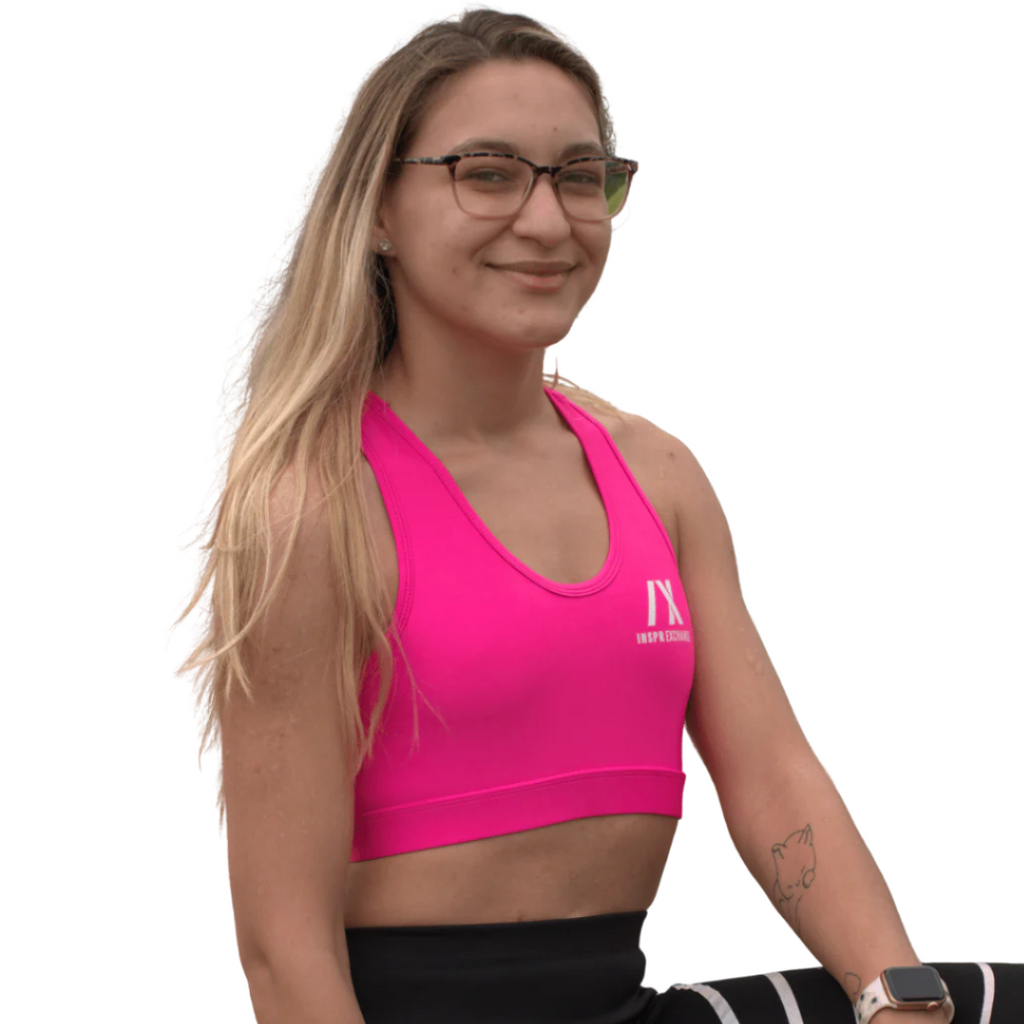 female athletic model posing for inspr exchange athletica while wearing pink virago sport bra with black leggings